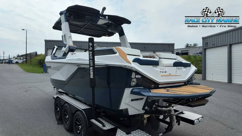 Slide: The Image of A modern Nautique P23 boat from 2027 on a trailer, featuring sleek design and spacious deck. - 7