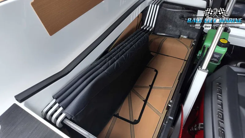 Slide: The Image of A storage compartment in the boat with folded seats and a Nautique engine. - 26