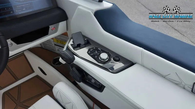 Slide: The Image of The image shows the cockpit of a 2027 Nautique P23 with modern controls and luxurious upholstery. - 43