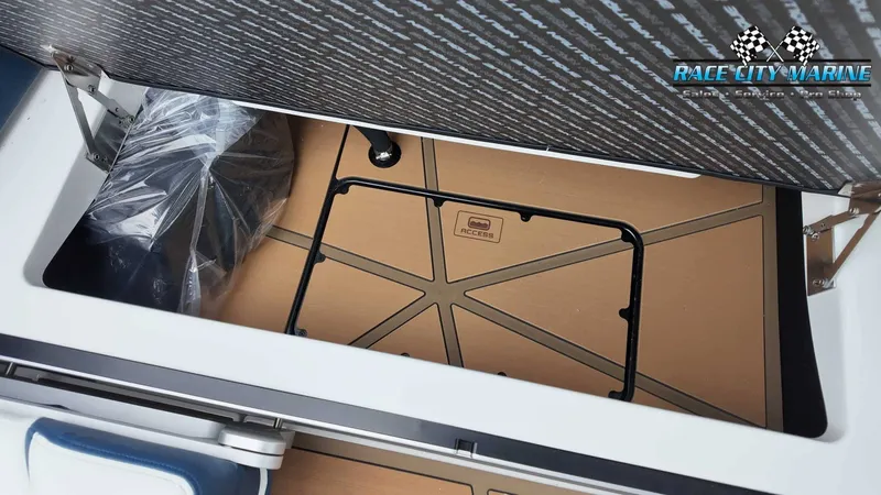 Slide: The Image of A storage compartment in the boat with a cover and a Race City Marine logo. - 33