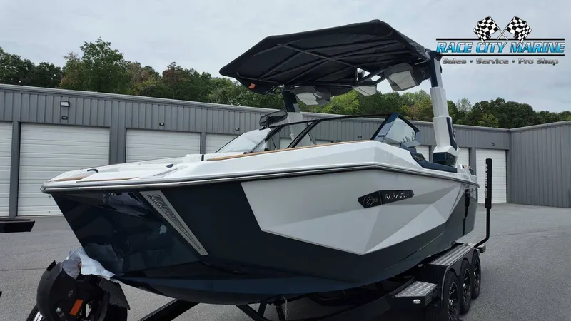 Slide: The Image of A modern Nautique P23 boat from 2027 sits on a trailer in front of a warehouse. - 6