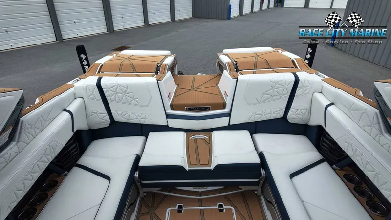 Slide: The Image of The image shows the luxurious interior of a Nautique P23 boat with white and blue seating. - 19