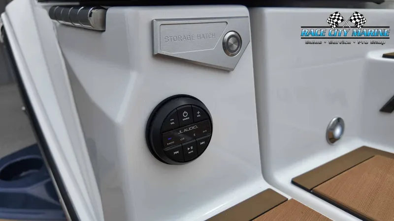 Slide: The Image of Close-up of a Nautique P23 boat section with JL Audio control and storage hatch. - 20