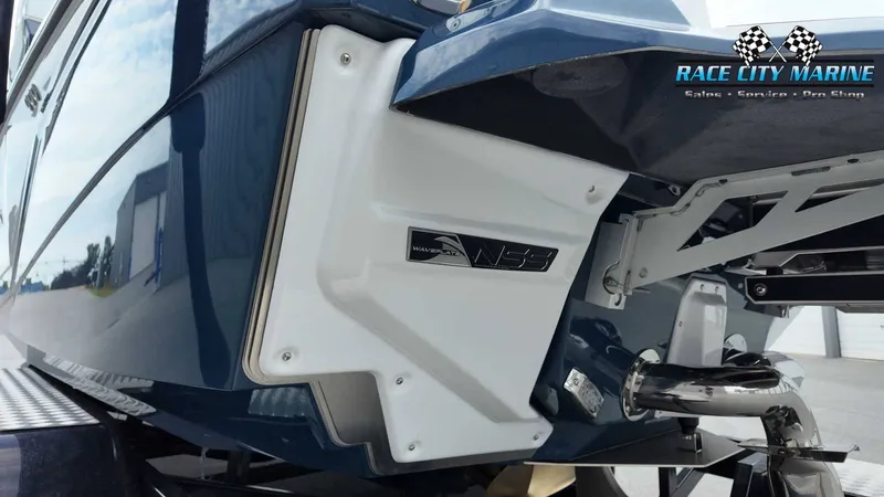 Slide: The Image of The image shows the stern of a blue 2027 Nautique P23 boat with an N55 logo. - 11