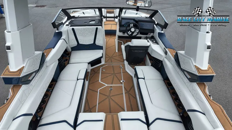Slide: The Image of The image shows the interior of a 2027 Nautique P23 with luxurious white and brown seating. - 21
