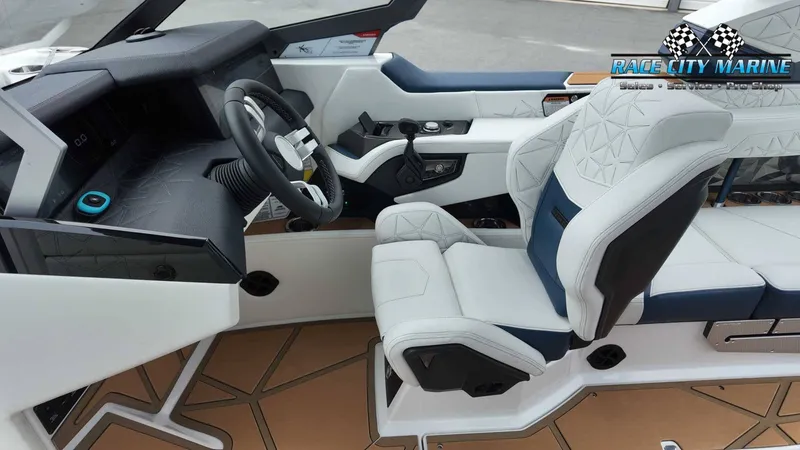 Slide: The Image of The image shows the cockpit of a modern Nautique P23 boat with luxurious white seats and a stylish steering wheel. - 39