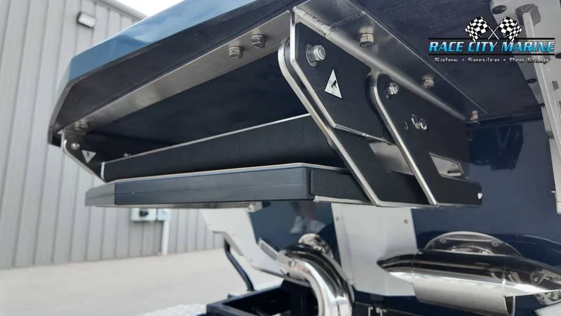 Slide: The Image of Close-up of the stern of a 2027 Nautique P23 with metal and plastic components. - 14