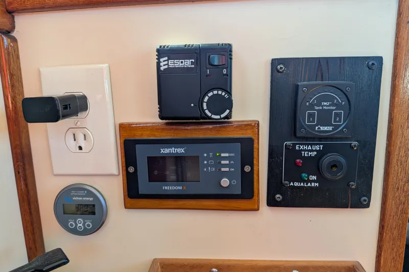 Slide: The Image of Control panel of a 1997 Nordic Tug 32 with various monitoring devices. - 35