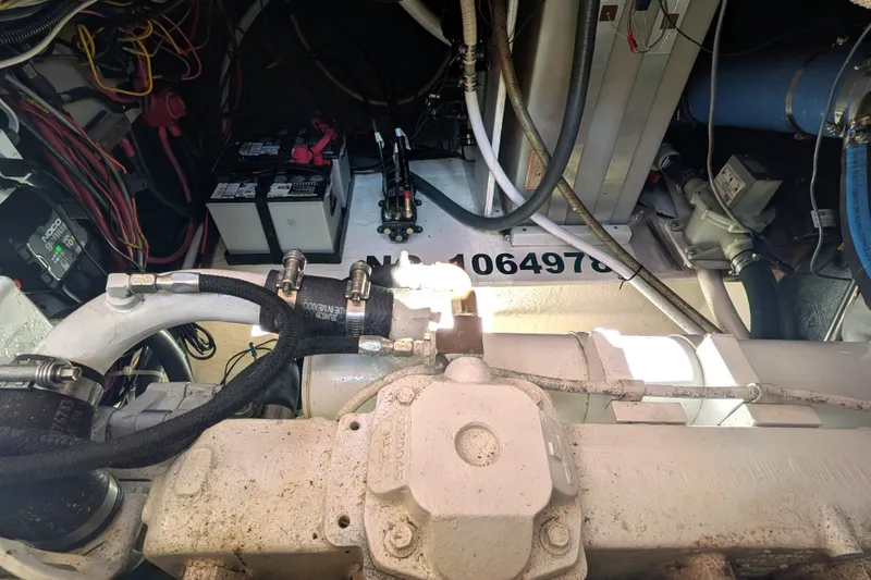 Slide: The Image of Engine room of a 1997 Nordic Tug 32, showcasing mechanical components and wiring. - 44