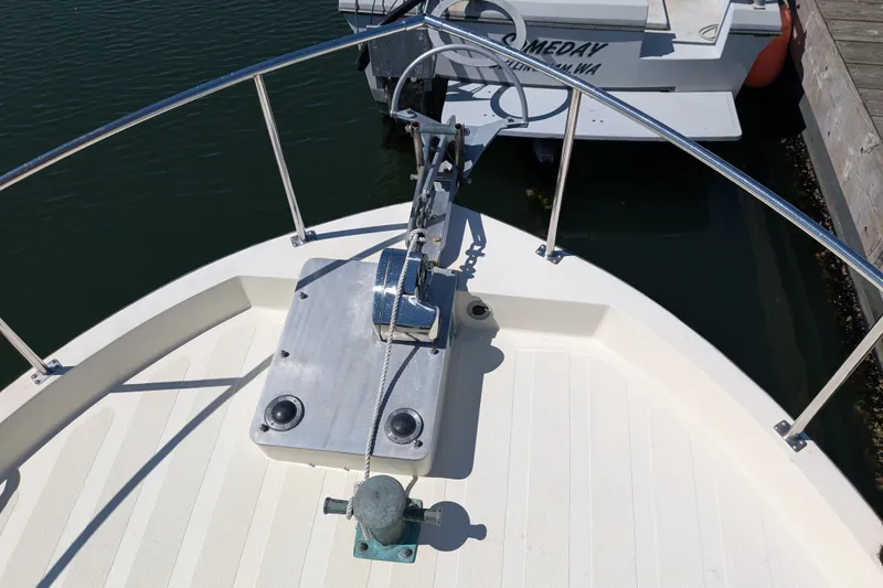 Slide: The Image of Bow of 1997 Nordic Tug 32 with anchor and railing in marina. - 7