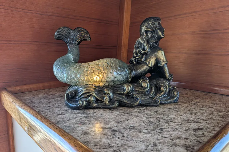 Slide: The Image of Bronze mermaid sculpture on a marble surface inside a 1997 Nordic Tug 32 boat. - 26
