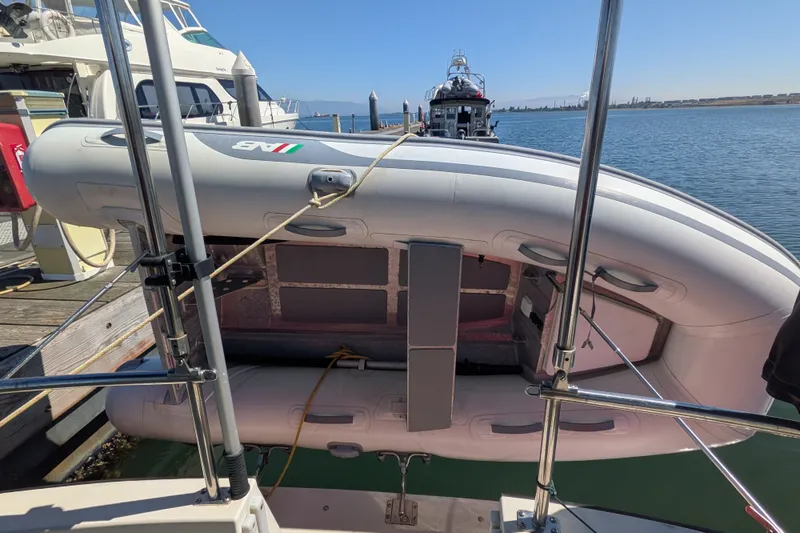 Slide: The Image of Inflatable boat secured on a 1997 Nordic Tug 32, docked at a marina. - 15