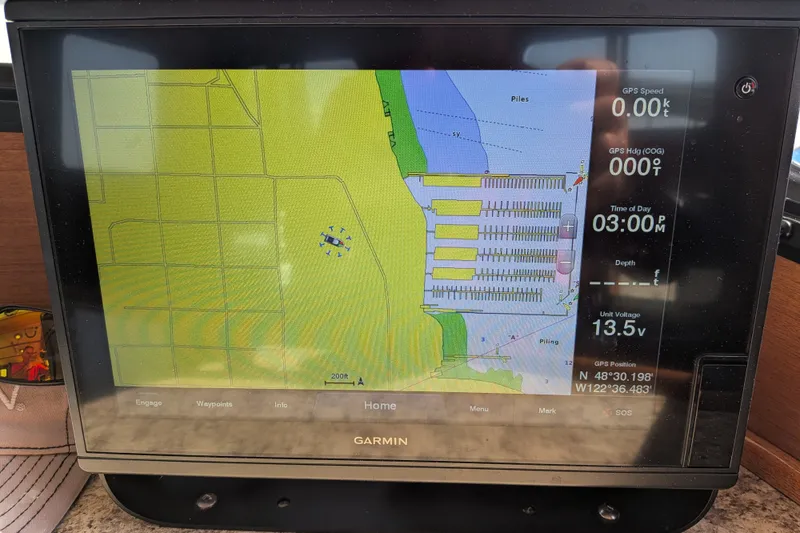 Slide: The Image of Garmin navigation display on a 1997 Nordic Tug 32, showing marina map and GPS data. - 32