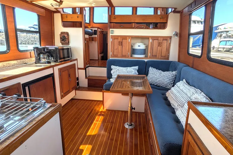 Slide: The Image of Interior of a 1997 Nordic Tug 32 with cozy seating and wooden finishes. - 19