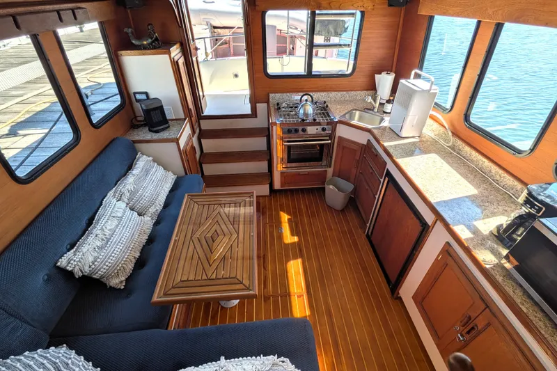 Slide: The Image of Cozy interior of a 1997 Nordic Tug 32 with kitchen and seating area. - 20