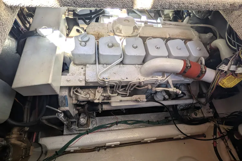 Slide: The Image of Engine compartment of a 1997 Nordic Tug 32, showcasing mechanical components and wiring. - 46