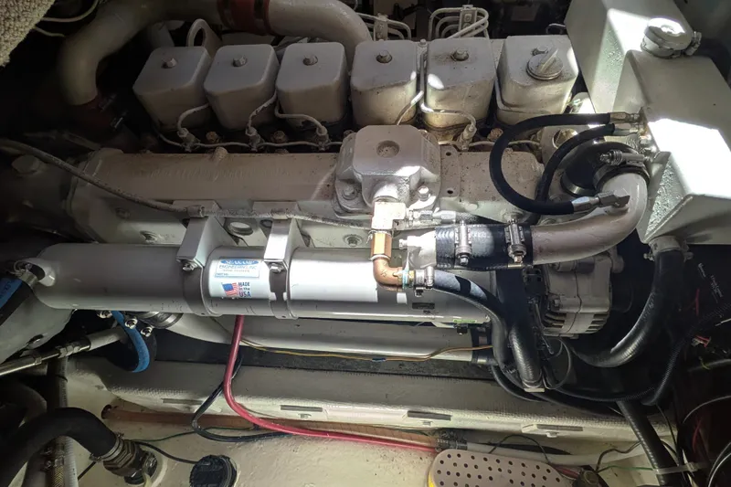 Slide: The Image of Engine compartment of a 1997 Nordic Tug 32, showcasing mechanical components and hoses. - 47