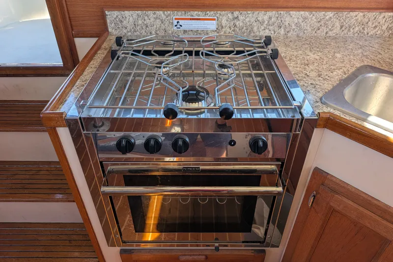 Slide: The Image of Stainless steel stove and oven in 1997 Nordic Tug 32 boat kitchen. - 23