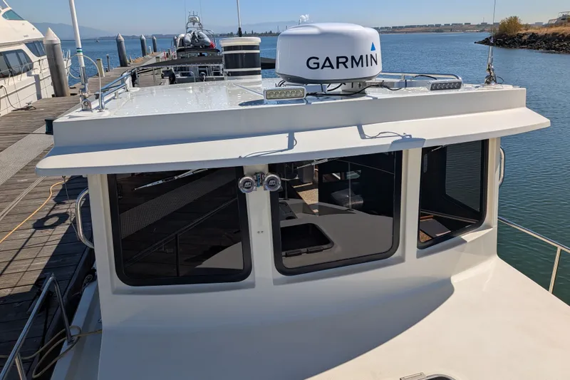 Slide: The Image of 1997 Nordic Tug 32 docked, featuring Garmin navigation equipment on the roof. - 8