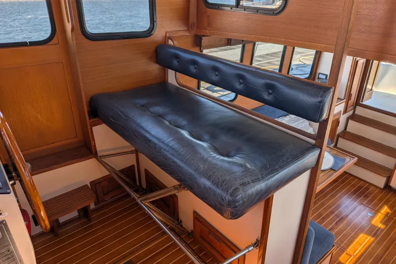 Slide: The Image of Interior of a 1997 Nordic Tug 32 with leather seating and wooden flooring. - 37