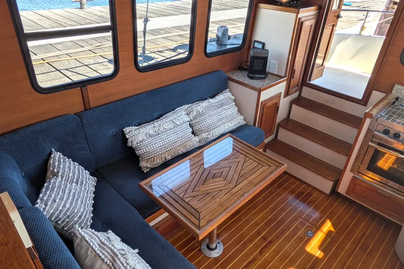Slide: The Image of Cozy interior of a 1997 Nordic Tug 32 with plush seating and wooden accents. - 21