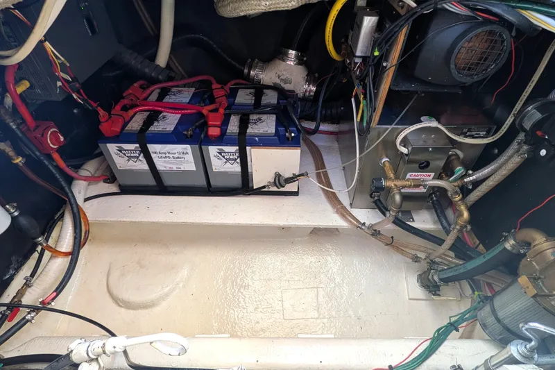 Slide: The Image of Engine room of a 1997 Nordic Tug 32 with batteries and wiring. - 45