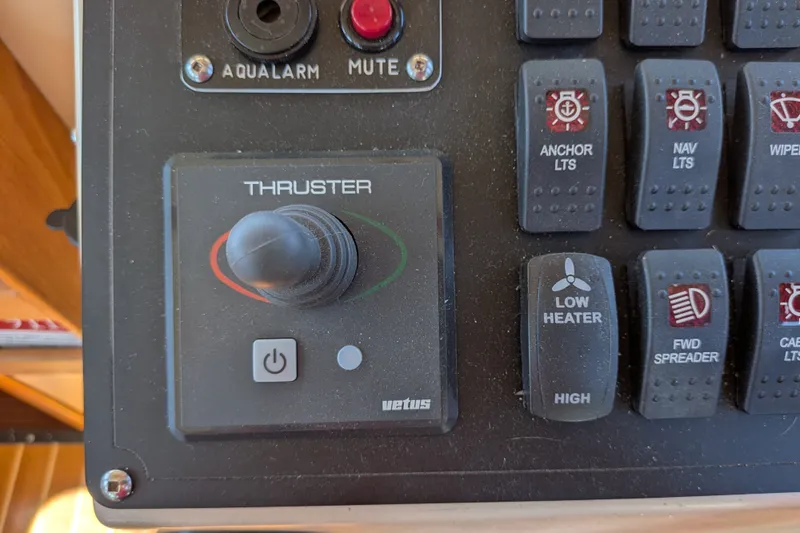Slide: The Image of Control panel of a 1997 Nordic Tug 32 featuring thruster and various switches. - 34