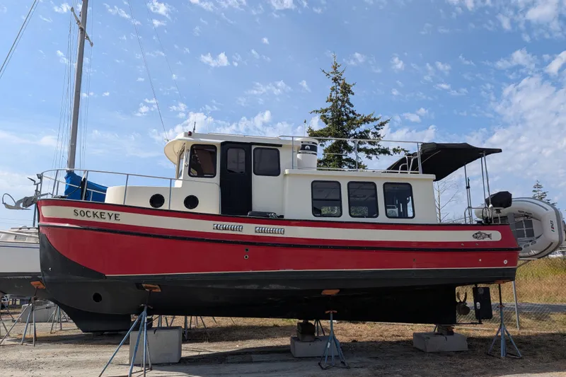 Slide: The Image of Red and white 1997 Nordic Tug 32 boat named Sockeye on dry dock. - 49