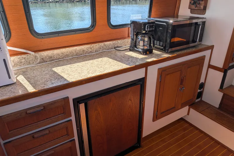 Slide: The Image of Kitchen area of a 1997 Nordic Tug 32 with microwave and coffee maker. - 24