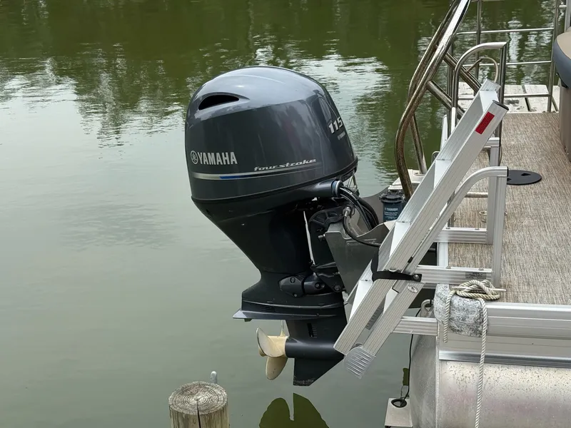 Slide: The Image of A Yamaha outboard motor is attached to the stern of a pontoon boat on calm water. - 6