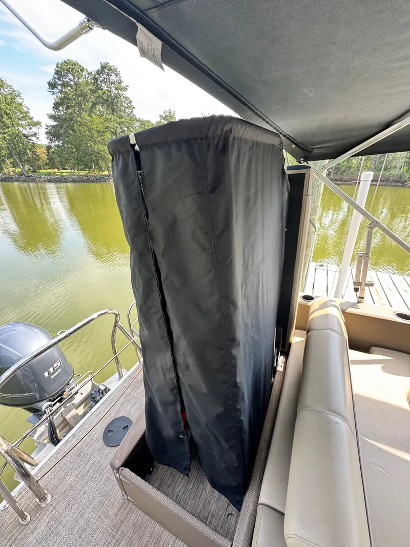 Slide: The Image of The image shows the stern of a 2022 Godfrey Sweetwater 2286 SFL pontoon boat with an outboard motor. - 18