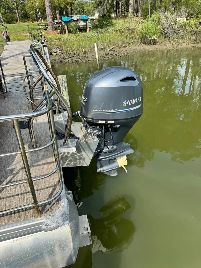 Slide: The Image of A 2022 Godfrey Sweetwater 2286 SFL with a Yamaha outboard motor, docked at a pier. - 5