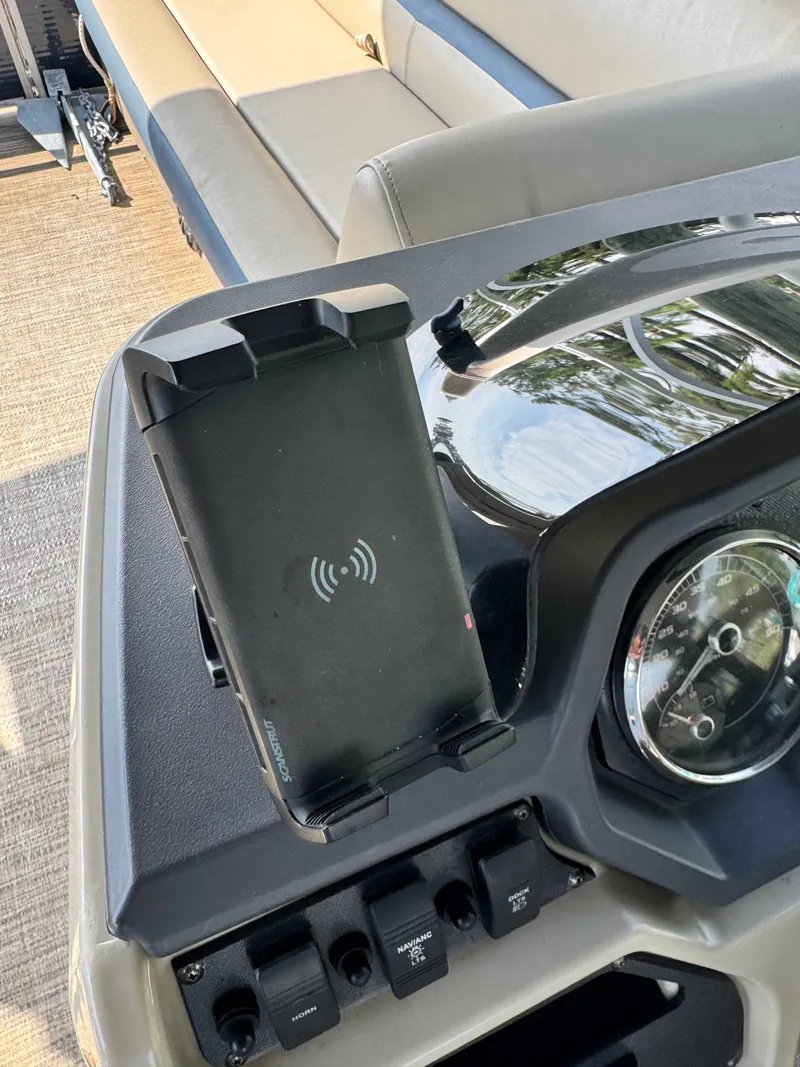 Slide: The Image of The image shows a boat dashboard with a smartphone holder and various switches. - 11