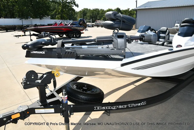 Slide: The Image of A white Ranger RT198P boat is on a trailer in an outdoor area. - 8