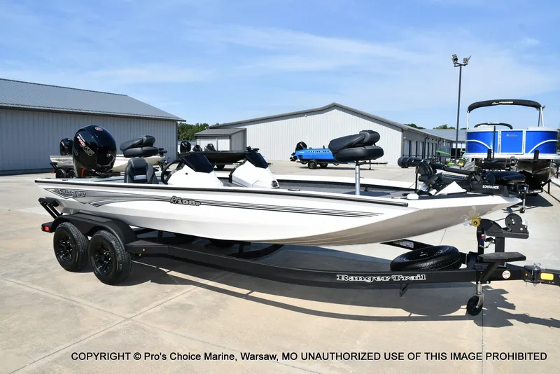 Slide: The Image of A white 2027 Ranger RT198P boat is on a trailer in an outdoor setting. - 2