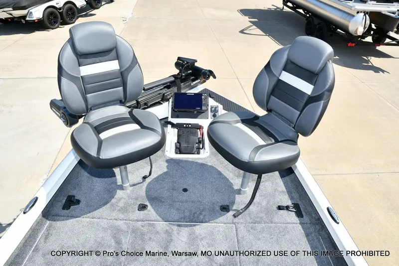 Slide: The Image of Two gray seats on a carpeted boat deck with a small screen in the center. - 23