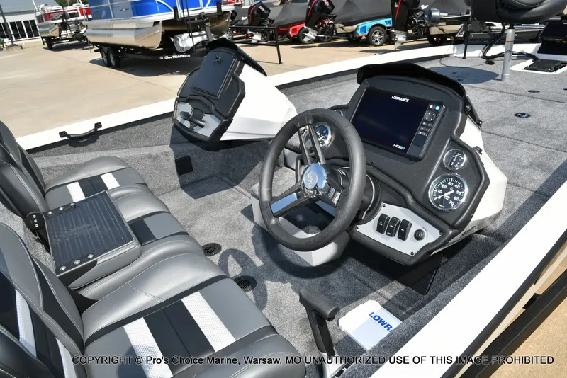 Slide: The Image of The image shows the cockpit of a Ranger RT198P boat with modern instruments and gray seating. - 29