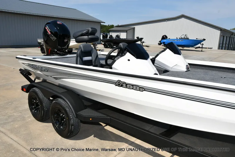 Slide: The Image of A white Ranger RT198P boat on a trailer, parked on a concrete lot. - 3