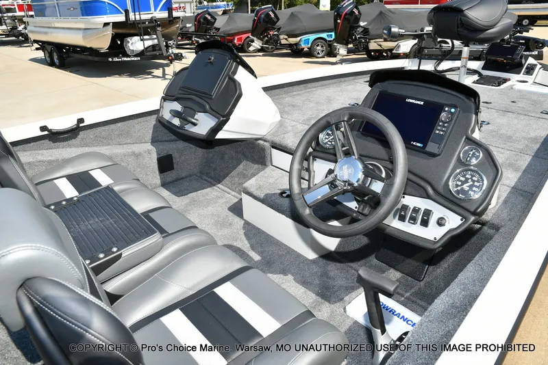 Slide: The Image of The image shows the cockpit of a Ranger RT198P boat with modern instruments and gray seating. - 13