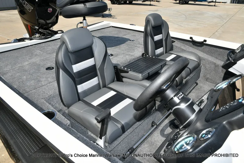 Slide: The Image of The image shows the cockpit of a Ranger RT198P boat with two gray seats and a steering wheel. - 12