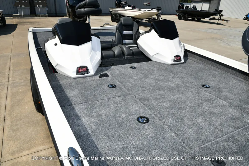 Slide: The Image of The image shows a Ranger RT198P boat with gray carpeting and two seats. - 27