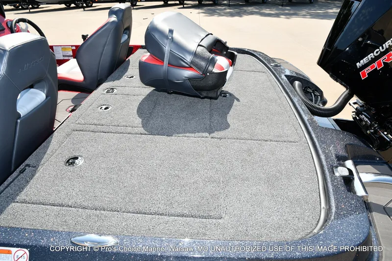 Slide: The Image of The image shows the spacious deck of a Nitro Z20 XL Pro boat with gray carpeting. - 25