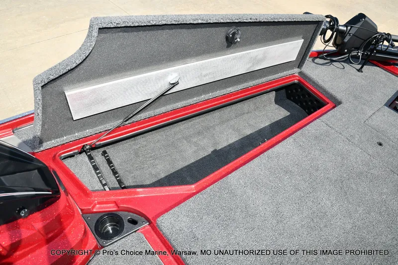 Slide: The Image of The image shows the open storage compartment of a 2027 Nitro Z20 XL Pro boat with gray carpeting. - 46