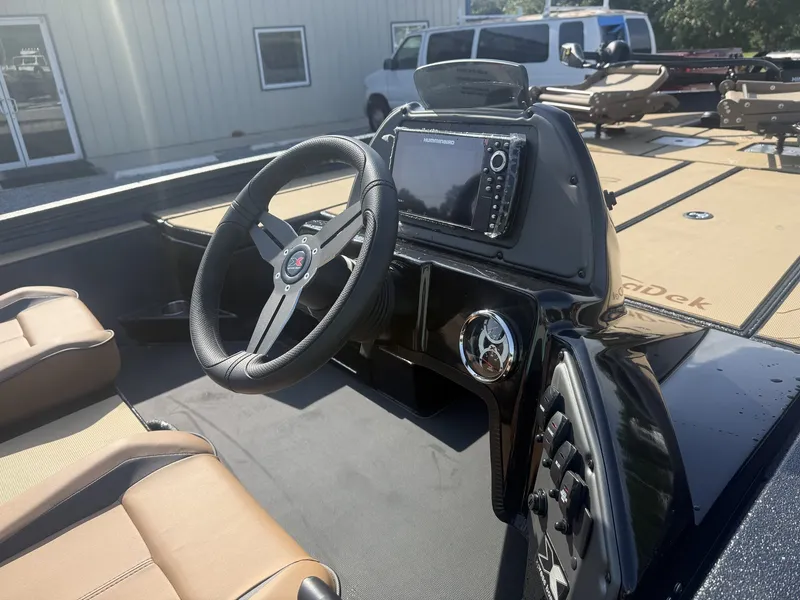 Slide: The Image of The image shows the cockpit of a 2027 Xpress H20 Crappie boat with modern steering and electronics. - 8
