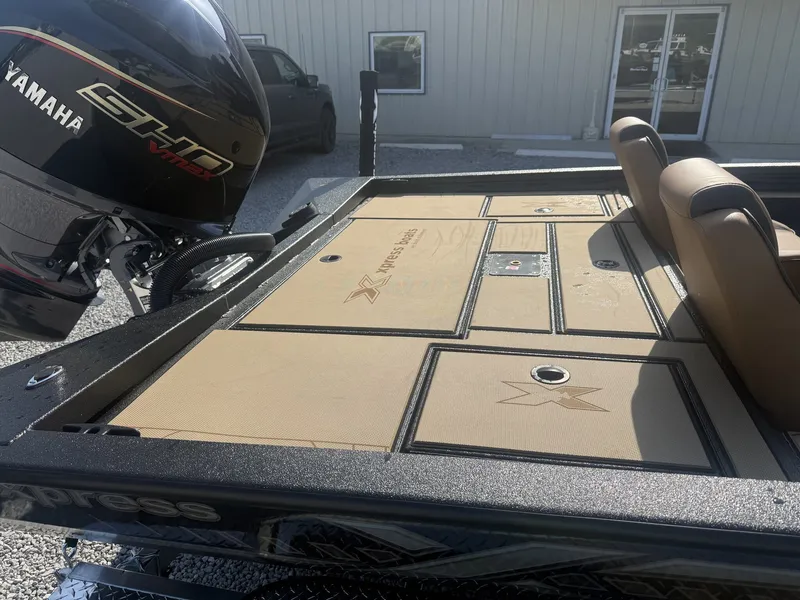 Slide: The Image of The image shows the deck of an Xpress H20 Crappie boat with a Yamaha engine. - 2