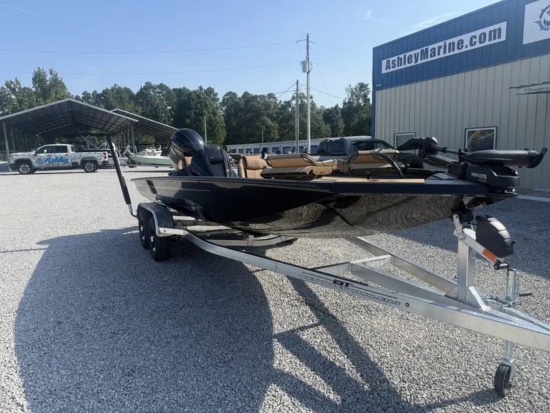 Slide: The Image of A 2027 Xpress H20 Crappie boat on a trailer in a gravel lot near a building. - 6