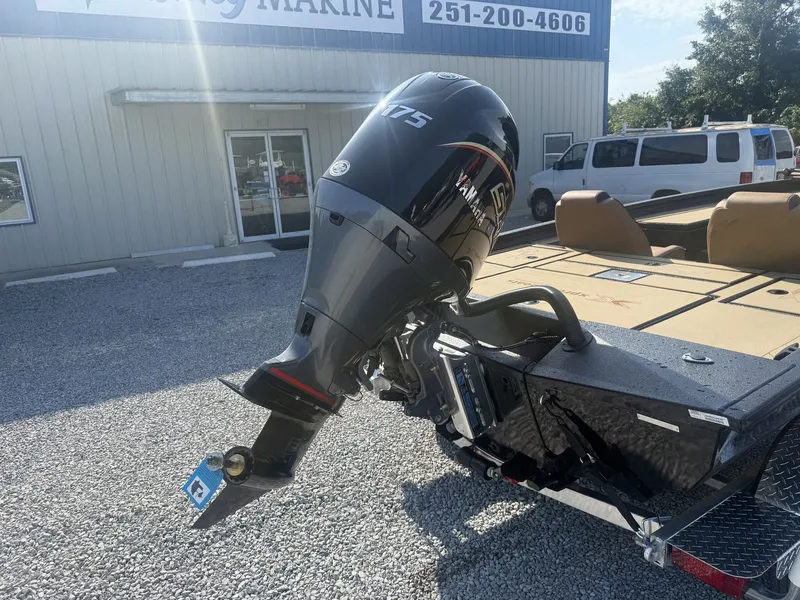 Slide: The Image of An Xpress H20 Crappie boat with a Yamaha 175 HP outboard motor, parked on a gravel lot. - 3