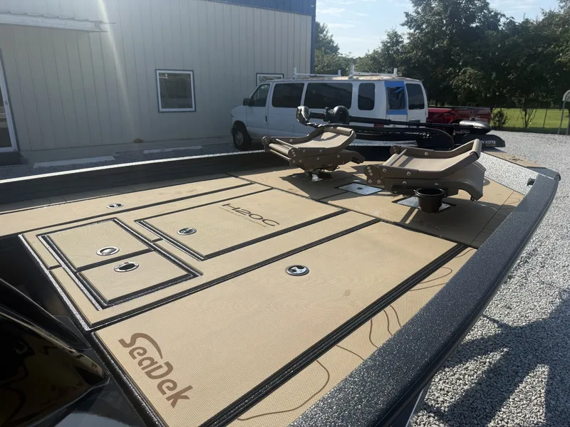 Slide: The Image of The image shows the deck of a 2027 Xpress H20 Crappie boat with SeaDek flooring. - 9