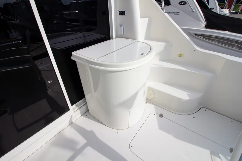 Slide: The Image of The 2006 Carver 33 Super Sport features a clean, white exterior deck with steps and storage. - 24