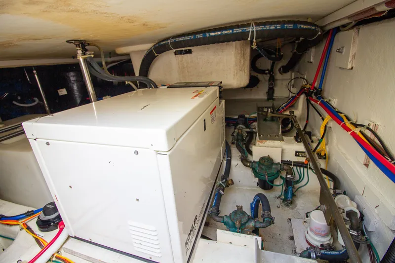 Slide: The Image of The engine room of a 2006 Carver 33 Super Sport showing engines and wiring. - 30